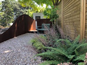 pathway to a shed with curved path and boundary walls