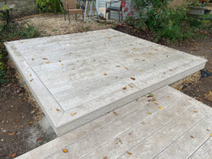 pale grey millboard composite decking forming a square shaped deck