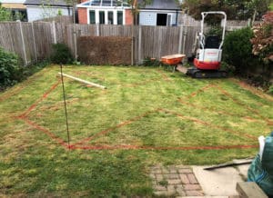 newbuild garden with red spray paint marking layout for new paths
