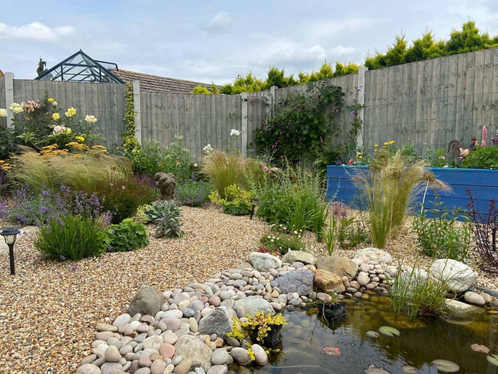 pretty gravel garden with wildlife pond in the foreground