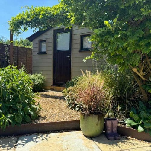 entrance to garden workshop framed by wisteria